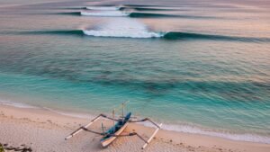 Rote Island surf spots featuring the long peeling left-hand waves of T-Land at sunset.