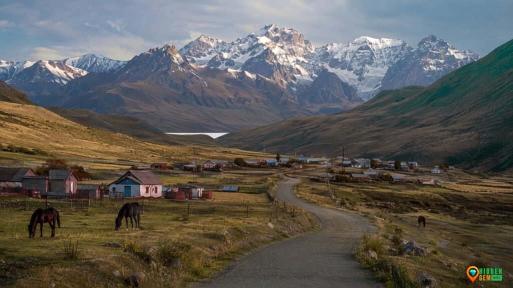 Kyrgyzstan Alpine Villages beneath snowy peaks with a winding road and traditional homes